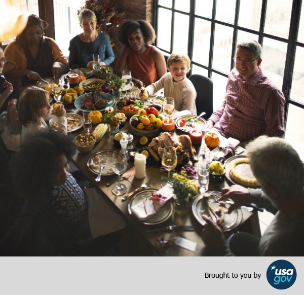Family sitting around a table enjoying a Thanksgiving meal.jpg