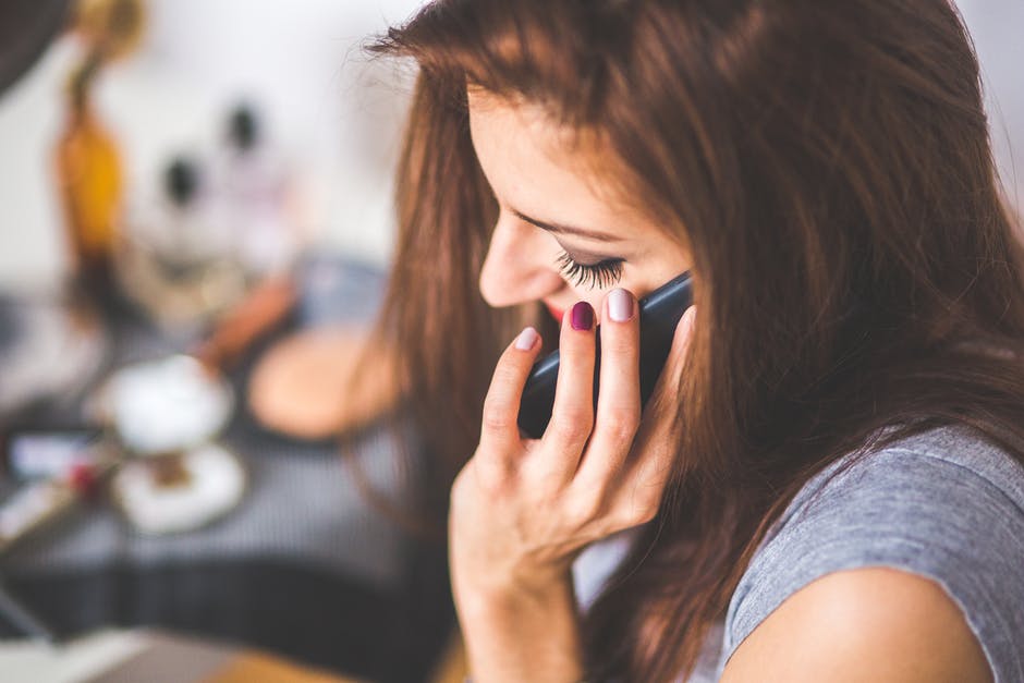 Woman on the phone. Takes you to FTC page on IRS imposter scams.