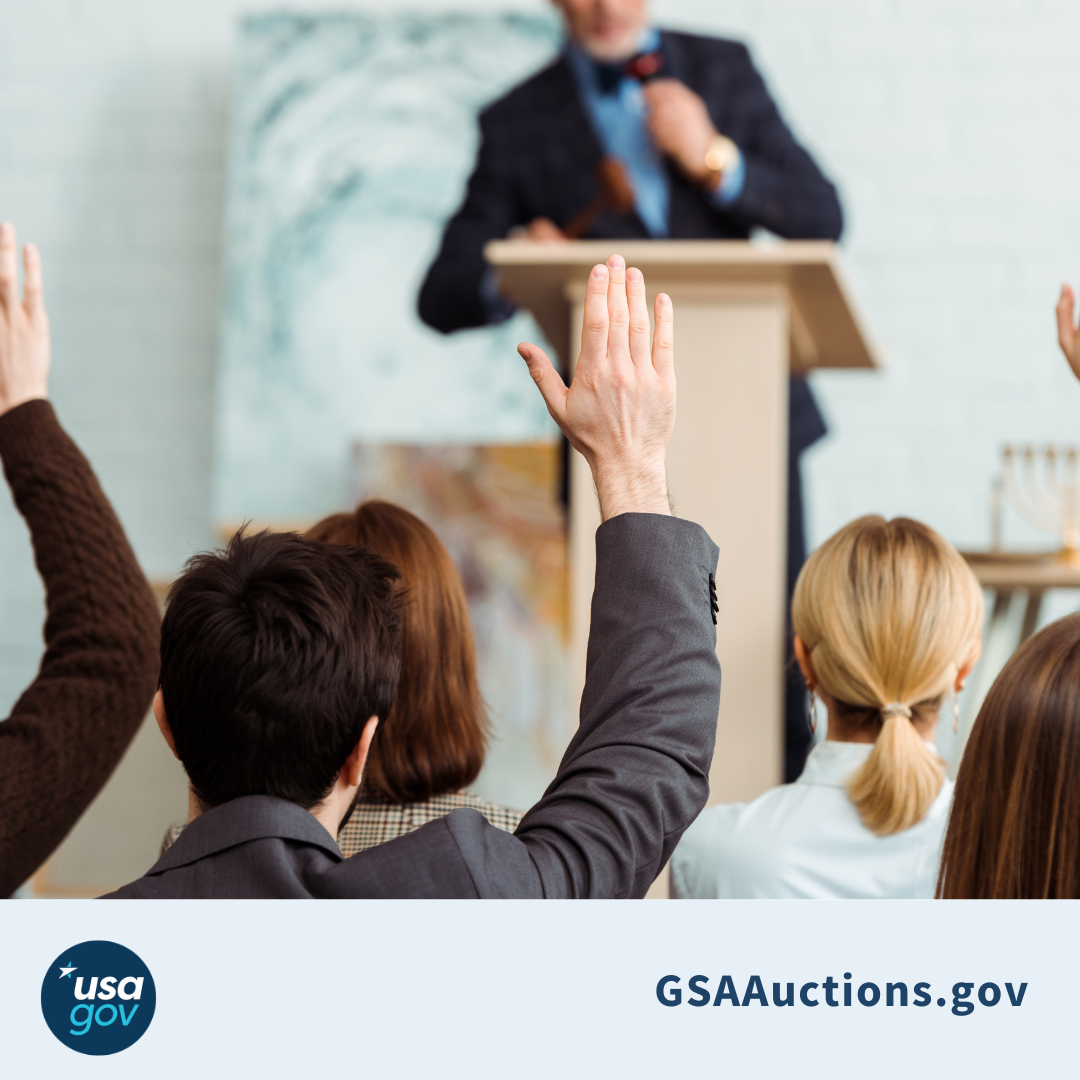 GSAAuctions.gov A group of bidders surround an auctioneer  above the USAGov logo and gsaauctions.gov