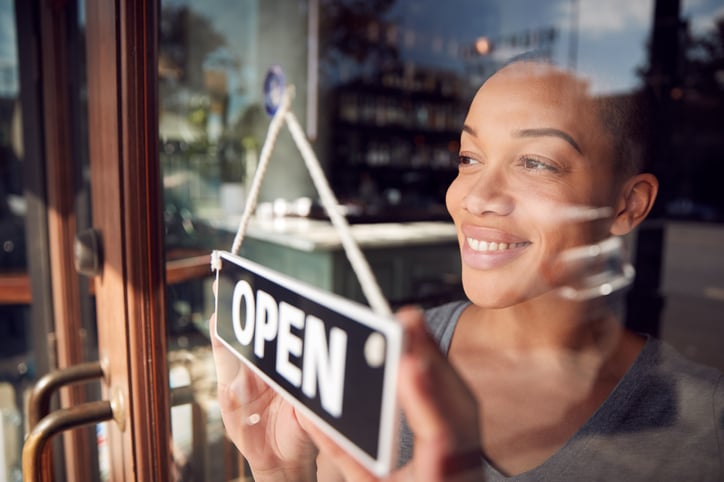 Small business owner Start Up Coffee Shop Or Restaurant Turning Round Open Sign On Door